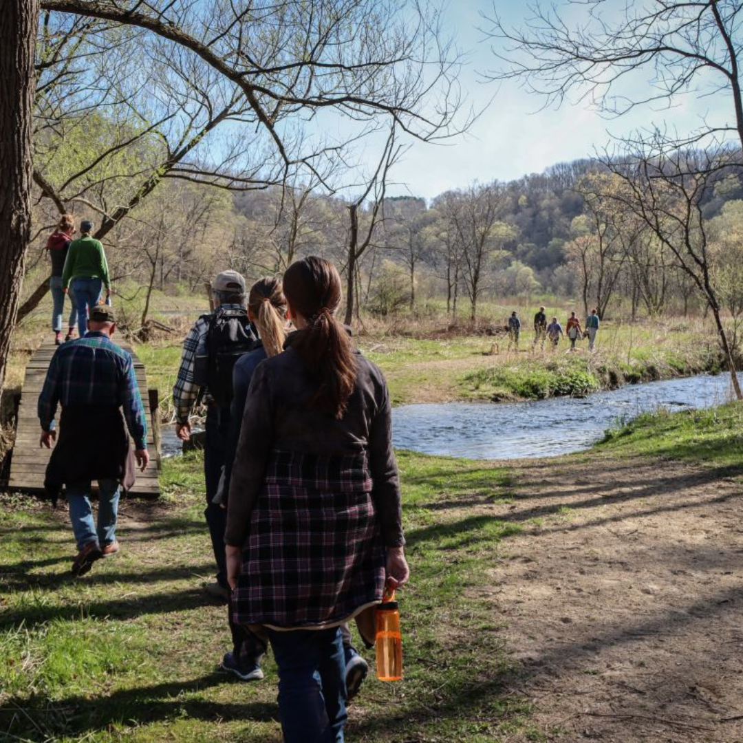Visitors hiking near a river in Viroqua